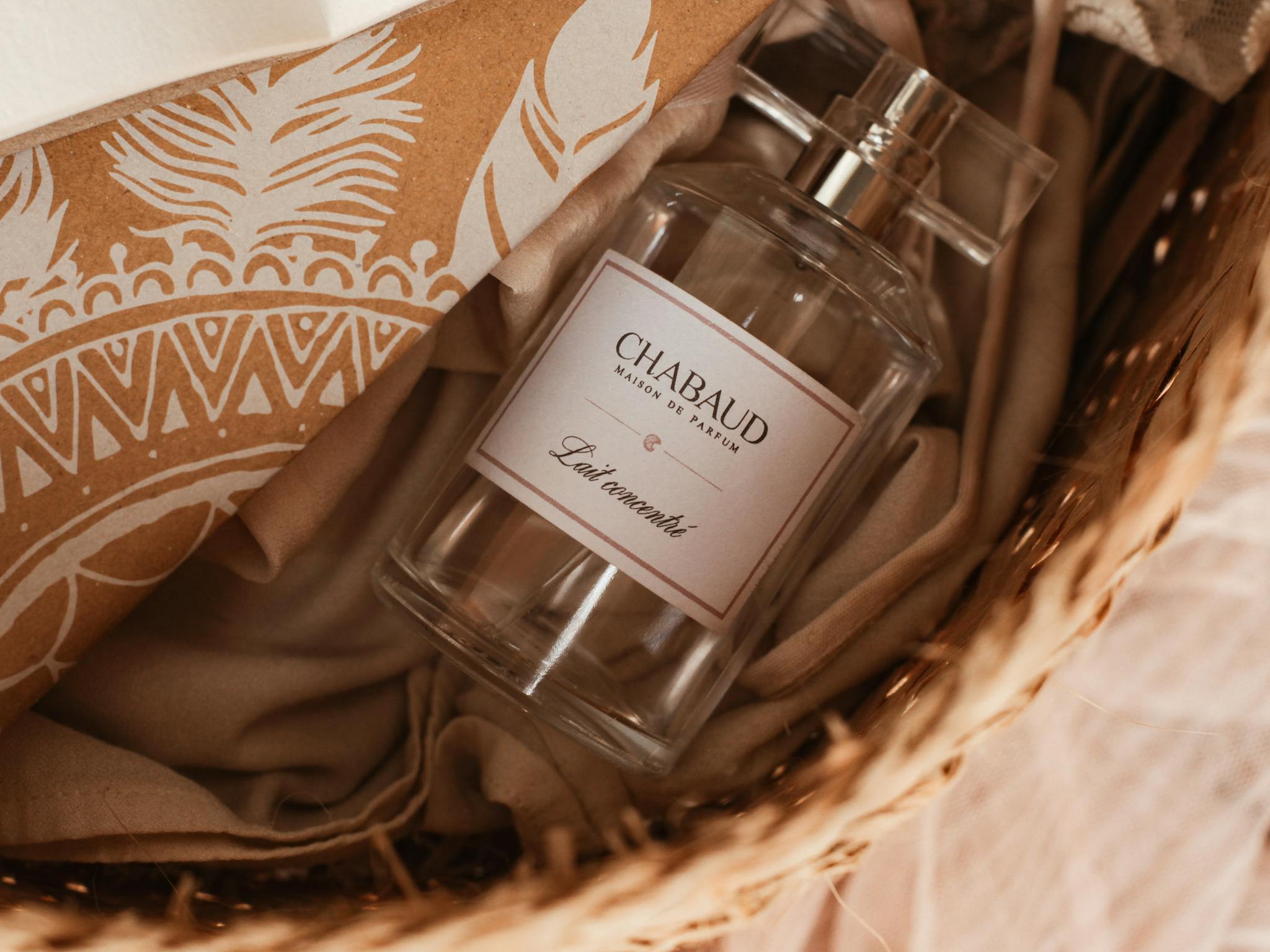 Close-up of Chabaud perfume bottle in a wicker basket with elegant packaging.